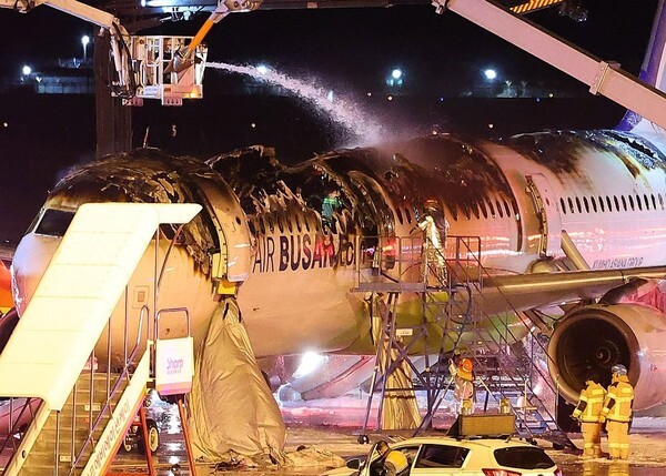 28일 오후 김해공항 계류장에서 승객 170명과 승무원 6명을 태우고 이륙을 준비하던 홍콩행 에어부산 항공기 BX391편 내부에서 불이 나 소방대원들이 진화 작업을 하고 있다.  [사진=연합]