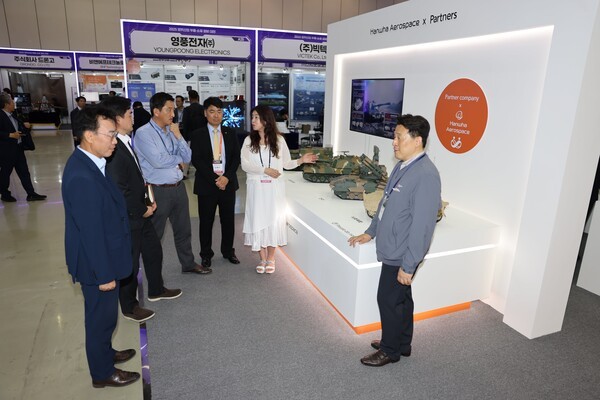 한화에어로스페이스 부스의 '상생협력존'을 방문한 관람객들에게 한화에어로스페이스 직원들이 협력업체가 참여한 대표 무기체계와 함께 협력업체 동반성장 프로그램 등에 대해 설명하고 있다. [출처=한화에어로스페이스]